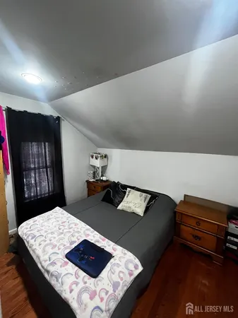 a view of a bedroom with furniture and window