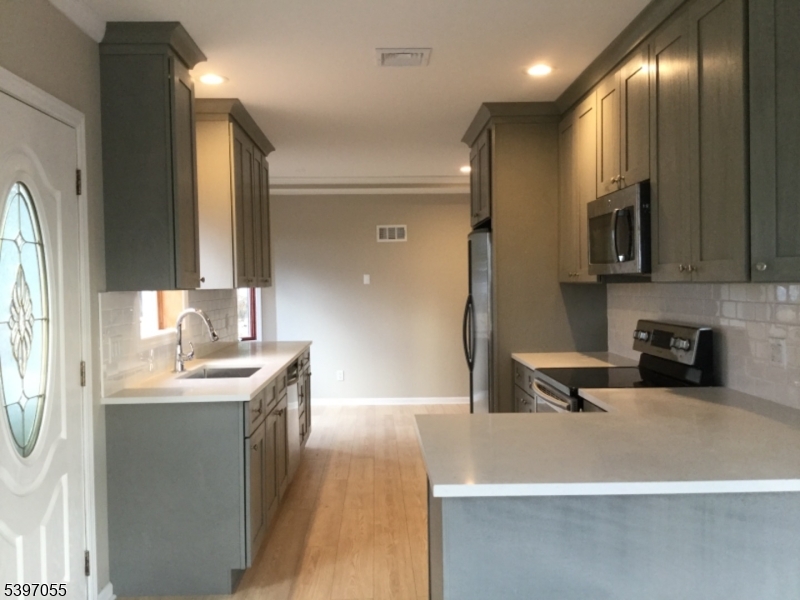 592 Dell Road Landing, NJ 07850 - Photo 12 of 39 a large kitchen with stainless steel appliances a sink a stove and a refrigerator