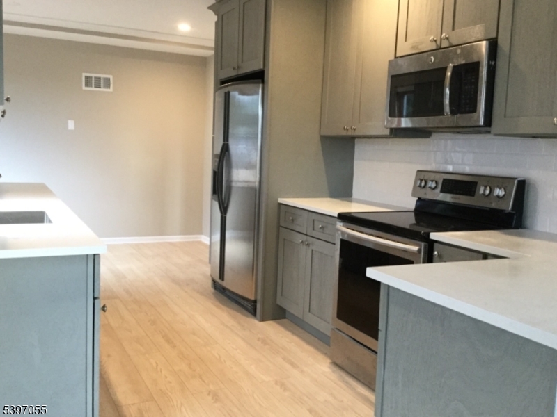 592 Dell Road Landing, NJ 07850 - Photo 14 of 39 a kitchen with stainless steel appliances a refrigerator a stove a microwave and cabinets