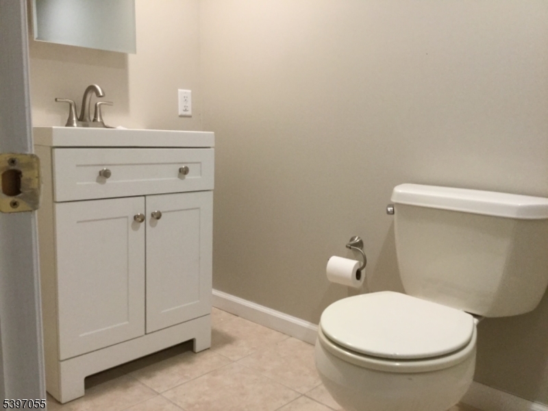 592 Dell Road Landing, NJ 07850 - Photo 17 of 39 a white toilet sitting next to a bathroom sink
