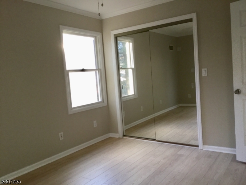 592 Dell Road Landing, NJ 07850 - Photo 24 of 39 an empty room with wooden floor and windows