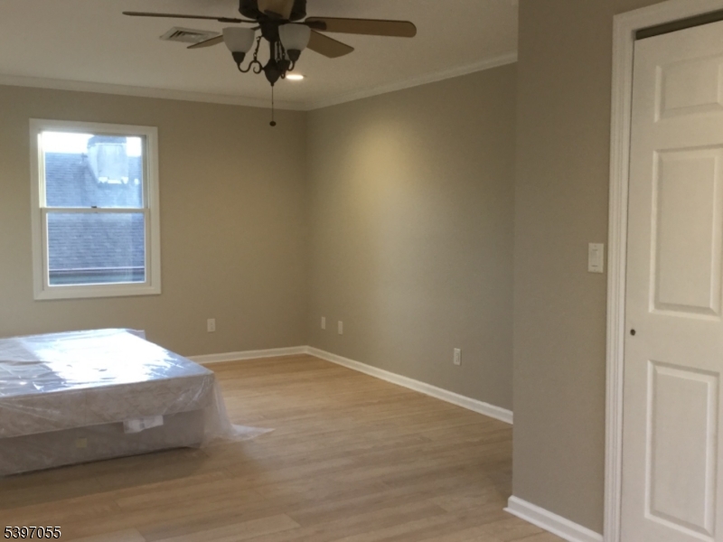 592 Dell Road Landing, NJ 07850 - Photo 28 of 39 en empty room with a window and ceiling fan