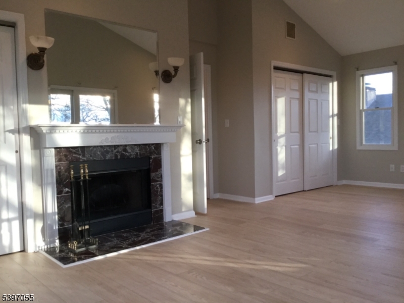 592 Dell Road Landing, NJ 07850 - Photo 29 of 39 an empty room with a fireplace and windows