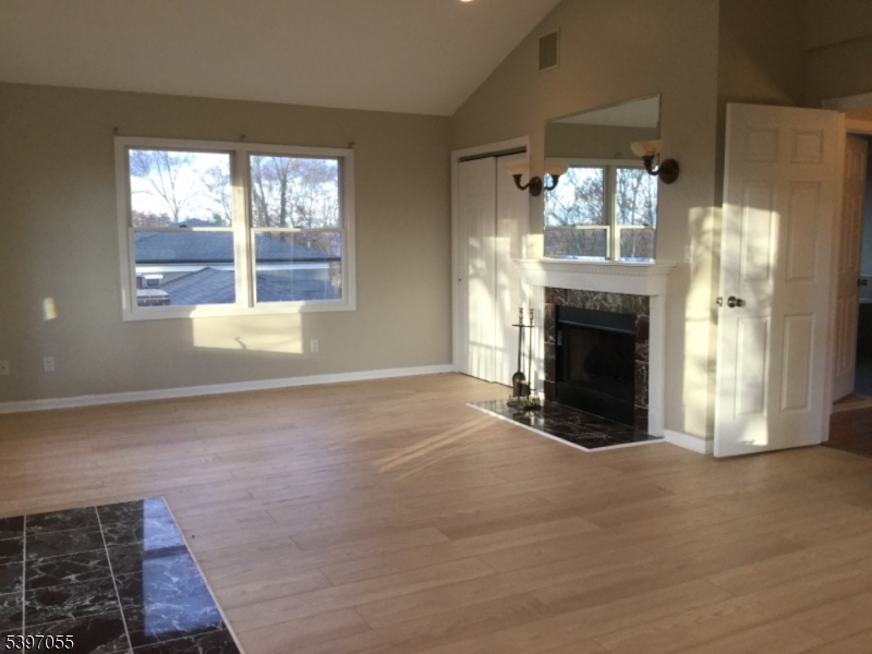 592 Dell Road Landing, NJ 07850 - Photo 31 of 39 a view of an empty room with a fireplace and a window