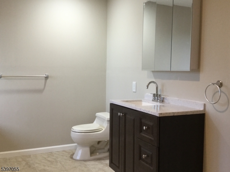 592 Dell Road Landing, NJ 07850 - Photo 36 of 39 a bathroom with a toilet a sink and mirror