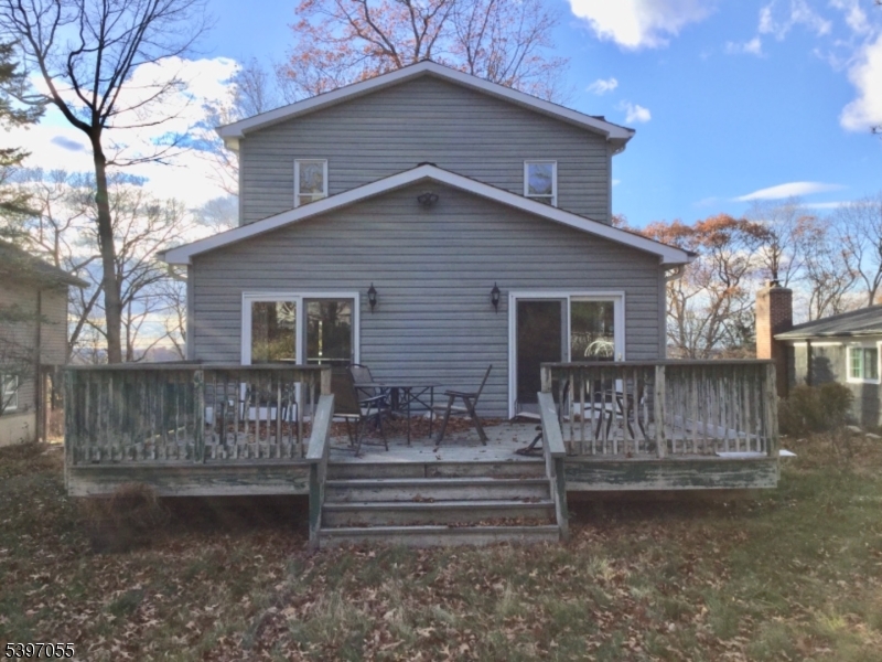 592 Dell Road Landing, NJ 07850 - Photo 4 of 39 a view of a house with wooden fence and a bench