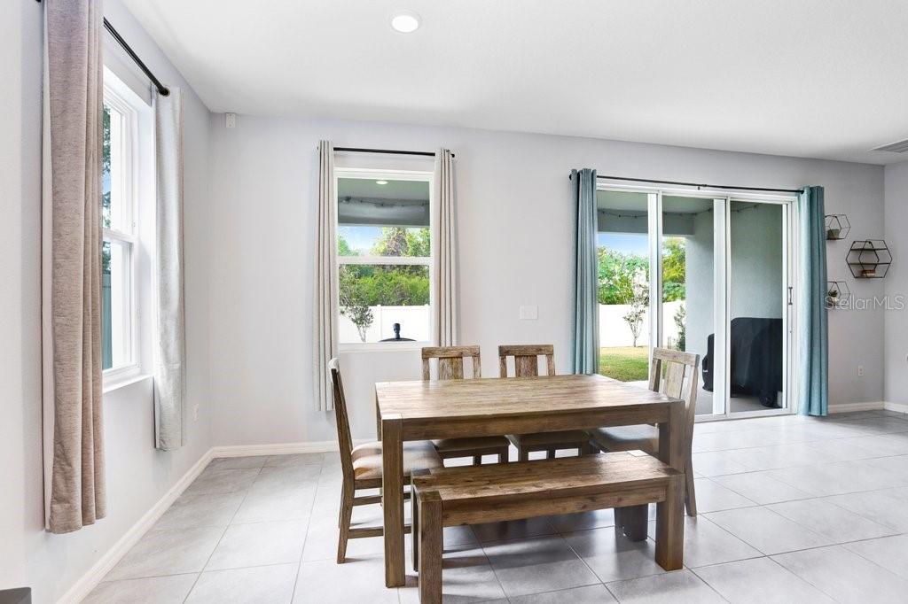 16619 Goose Ribbon Place Wimauma, FL 33598 - Photo 13 of 38 a view of a dining room with furniture and window