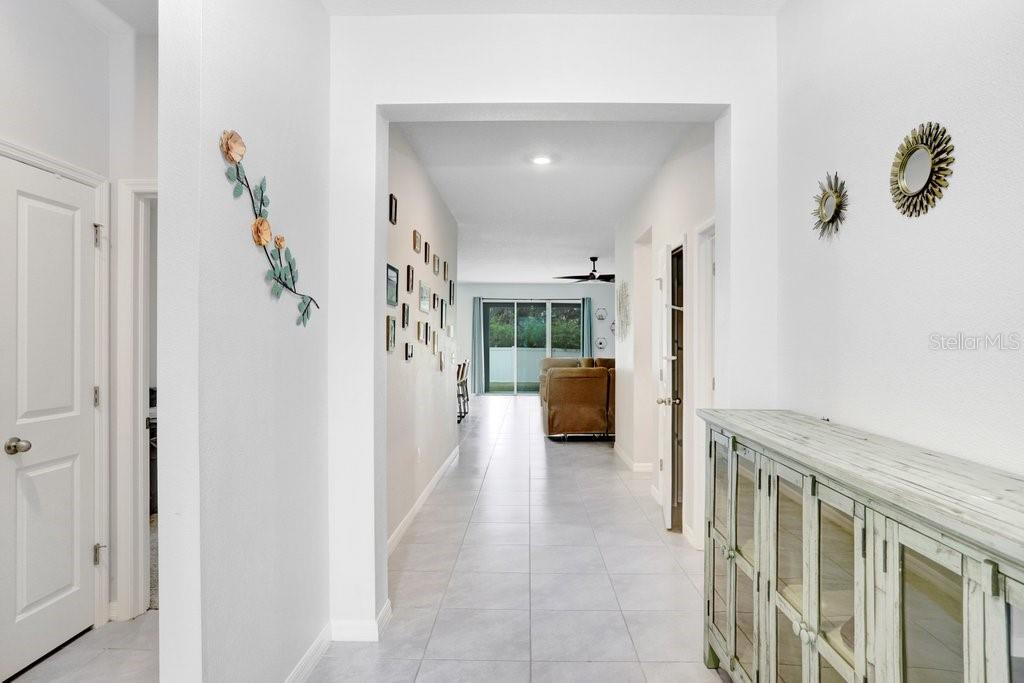 16619 Goose Ribbon Place Wimauma, FL 33598 - Photo 6 of 38 a view of a hallway with livingroom and furniture