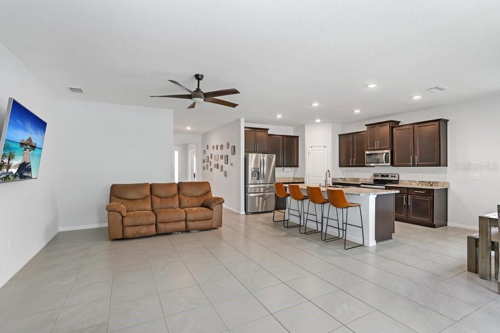 16619 Goose Ribbon Place Wimauma, FL 33598 - Photo 9 of 38 a living room with furniture and kitchen view
