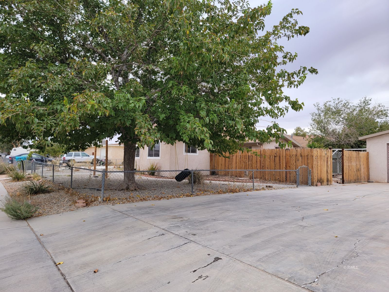 345 South Gordon Street Ridgecrest, CA 93555 - Photo 2 of 22 a view of a backyard with a tree