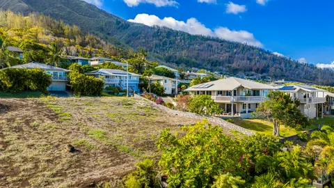 a view of a house with a big yard and large trees