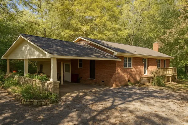 a front view of a house with a garden and patio
