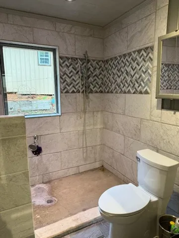 a white toilet sitting next to a bathroom sink