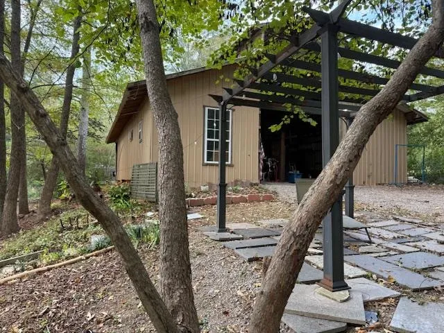 a view of a yard with plants and trees