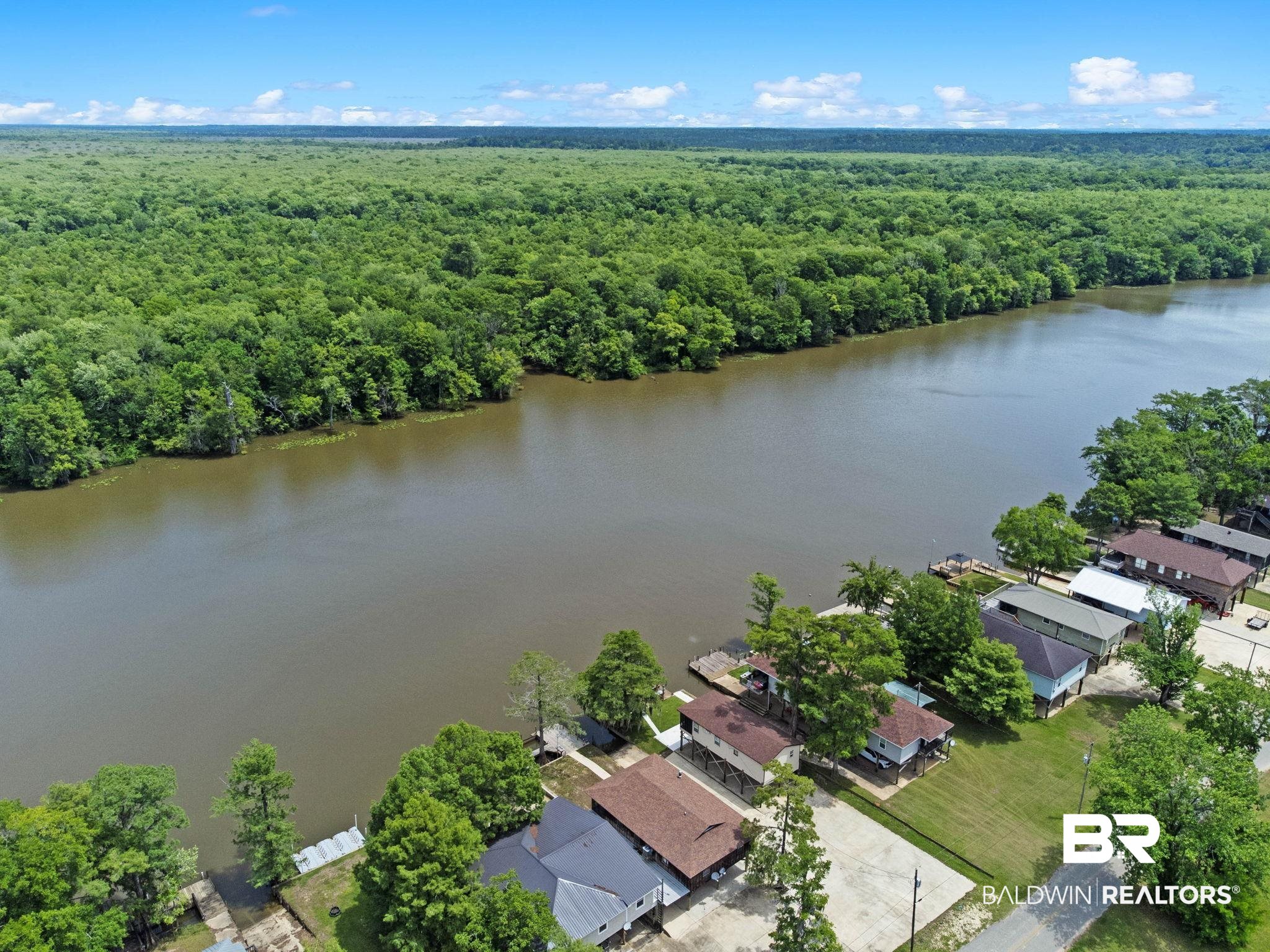 8153 Bryant's Lndg Road Stockton, AL 36579 - Photo 87 of 87 Waterfront properties situated along a riverbank, featuring individual docks and mature trees