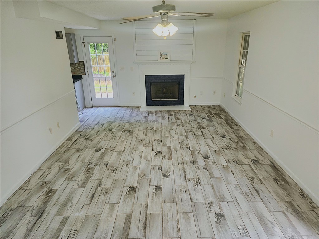 328 Springfield Circle Easley, SC 29642 - Photo 10 of 29 A welcoming interior with durable tile flooring and a focal fireplace offers a relaxed living space.