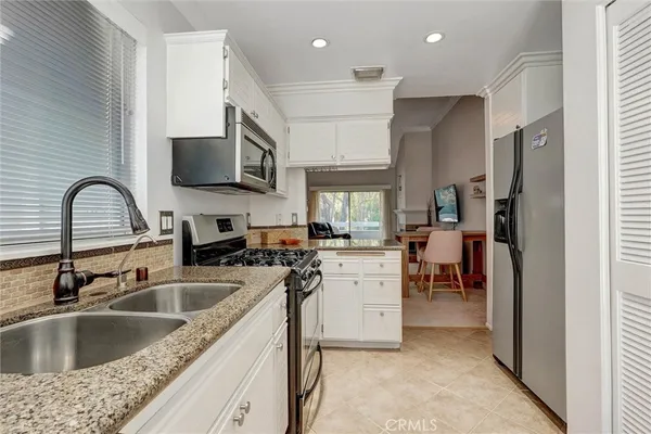 a kitchen with a sink cabinets and appliances