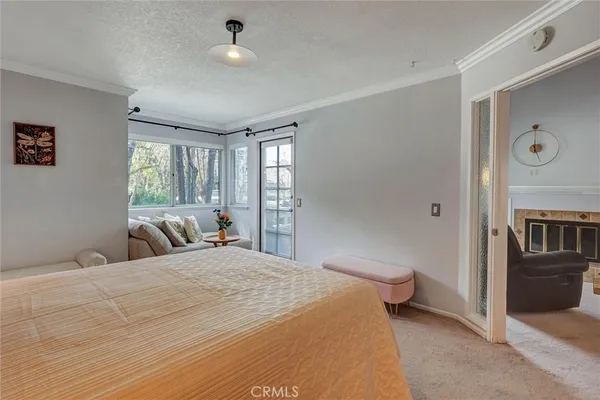 a bedroom with a bed and glass windows