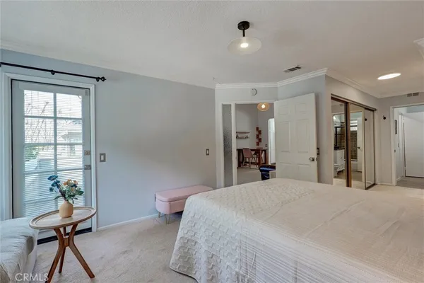 a bedroom with a bed and a potted plant