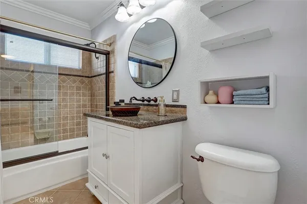 a bathroom with a toilet a sink and a mirror