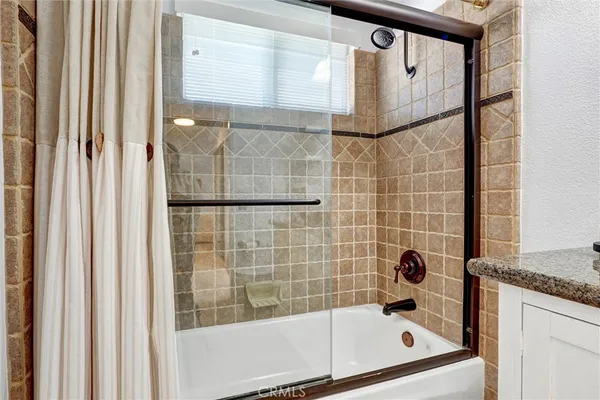 a bathroom with a bathtub and shower