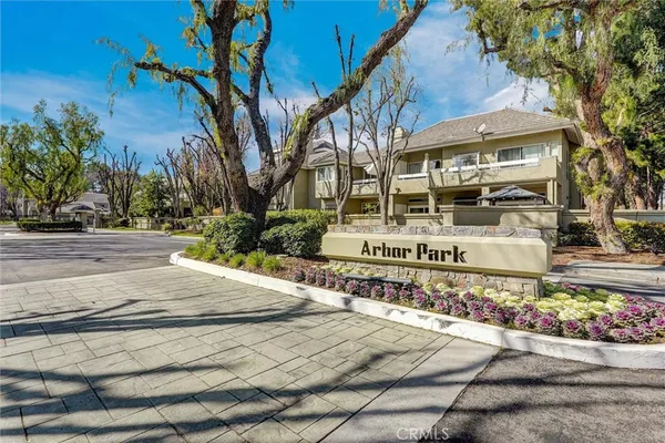 a sign board with buildings in the background