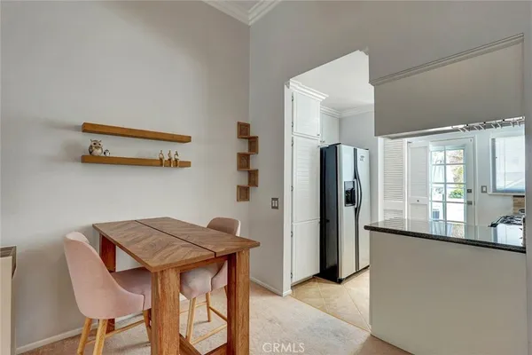 a view of a dining room with furniture and a window