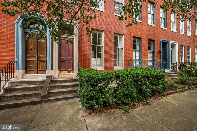 a view of a brick building next to a yard
