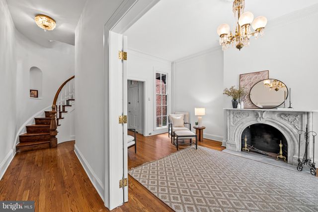 a view of living room with furniture and a fireplace