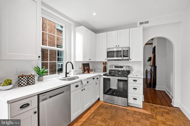 a kitchen with stainless steel appliances granite countertop a stove sink and refrigerator