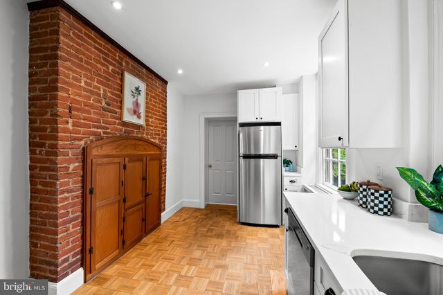 a kitchen with stainless steel appliances a refrigerator sink and cabinets
