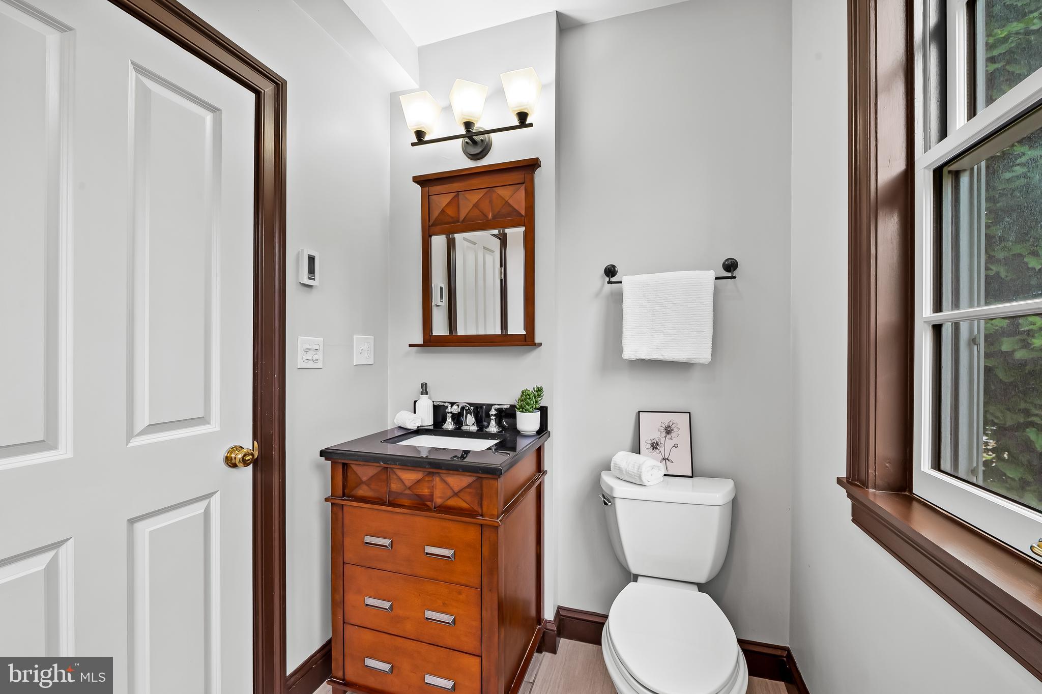 1431 Park Avenue Baltimore, MD 21217 - Photo 23 of 55 a bathroom with a toilet a sink and a mirror