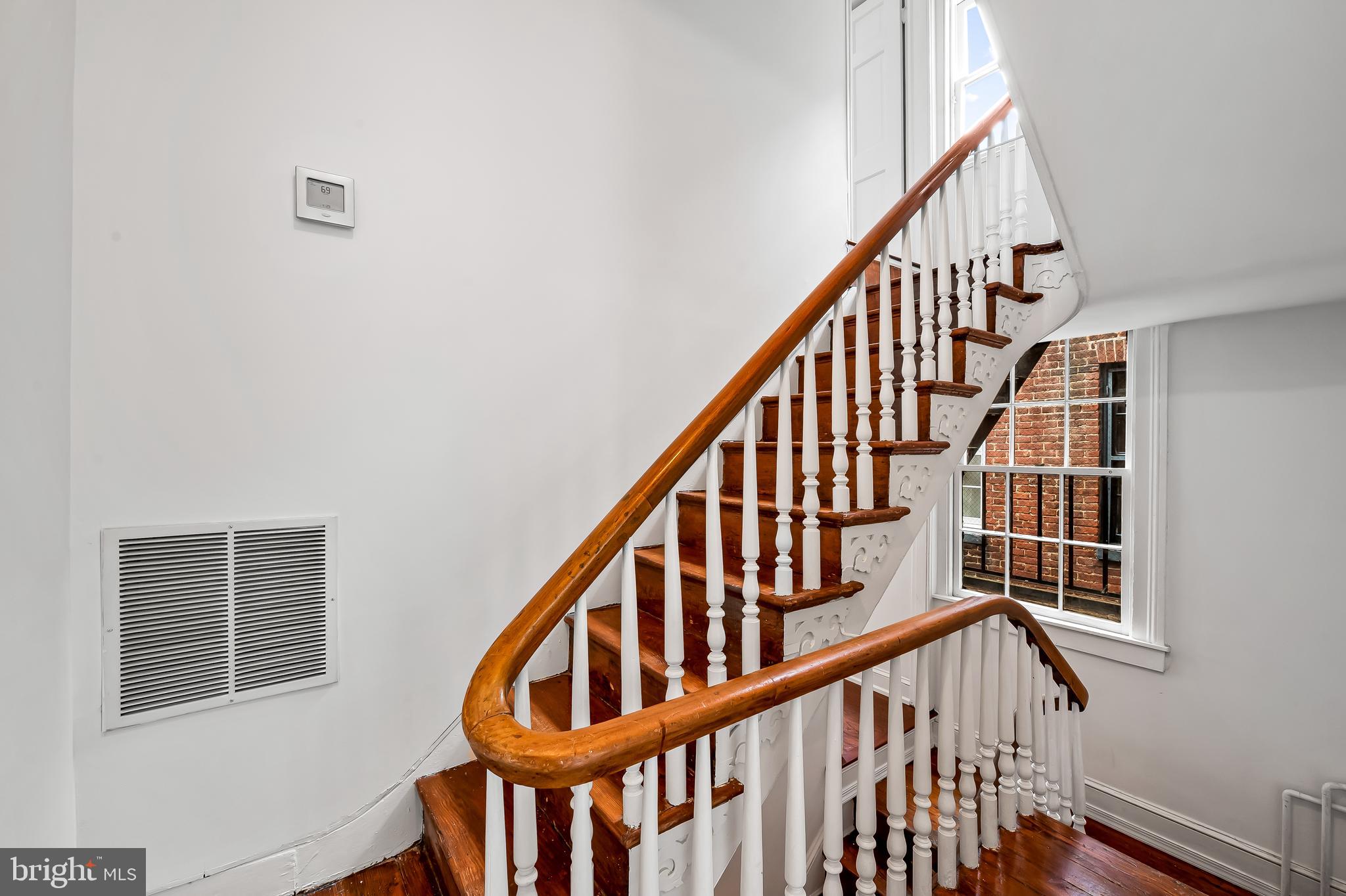 1431 Park Avenue Baltimore, MD 21217 - Photo 25 of 55 a view of staircase with railing and white walls