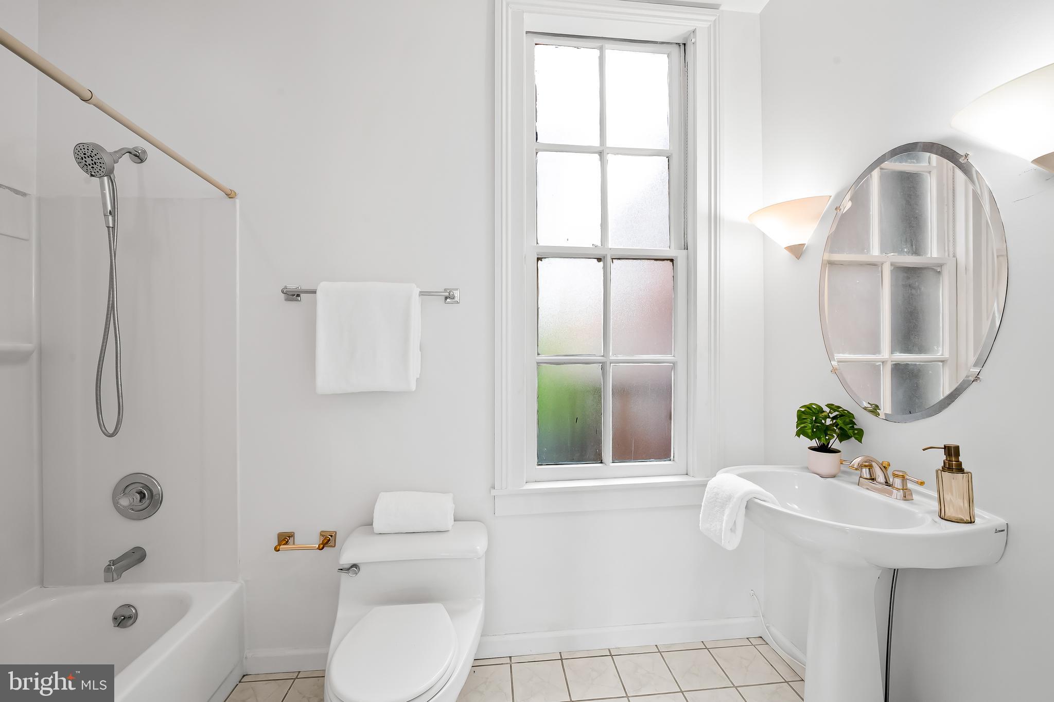 1431 Park Avenue Baltimore, MD 21217 - Photo 31 of 55 a bathroom with a sink a toilet and shower