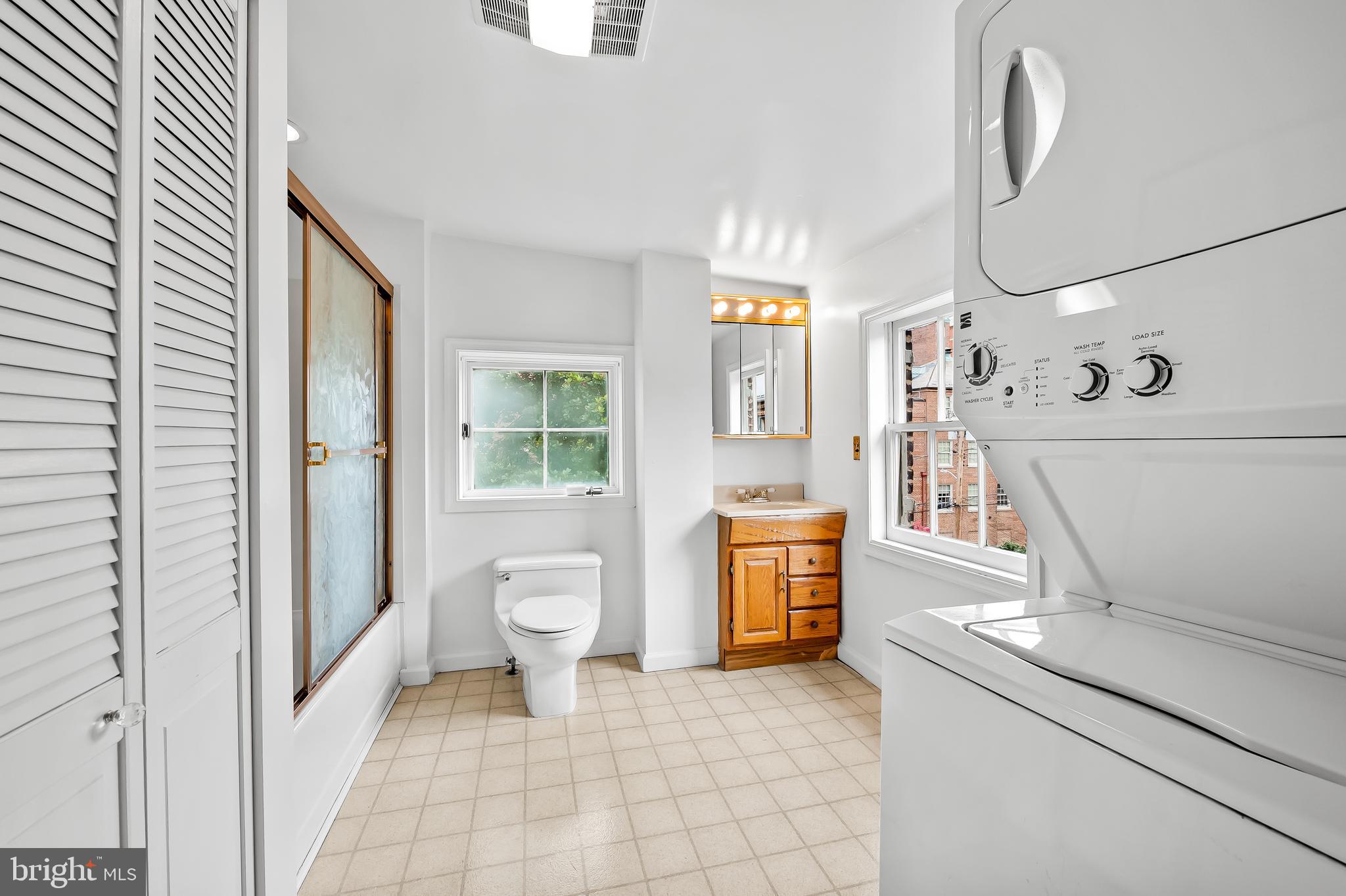 1431 Park Avenue Baltimore, MD 21217 - Photo 36 of 55 a spacious bathroom with a granite countertop sink a toilet and a shower