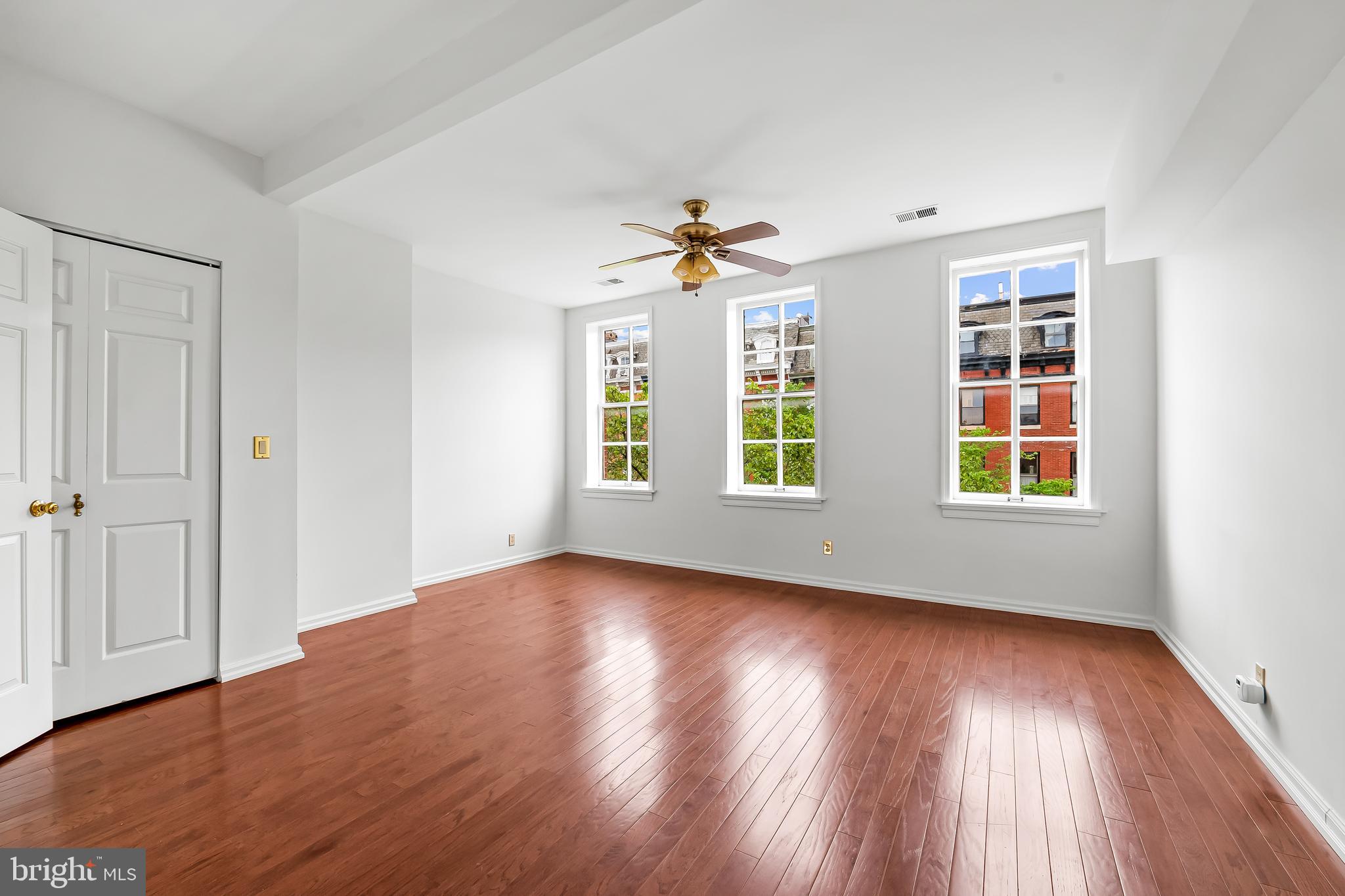 1431 Park Avenue Baltimore, MD 21217 - Photo 37 of 55 a view of an empty room with wooden floor and a window