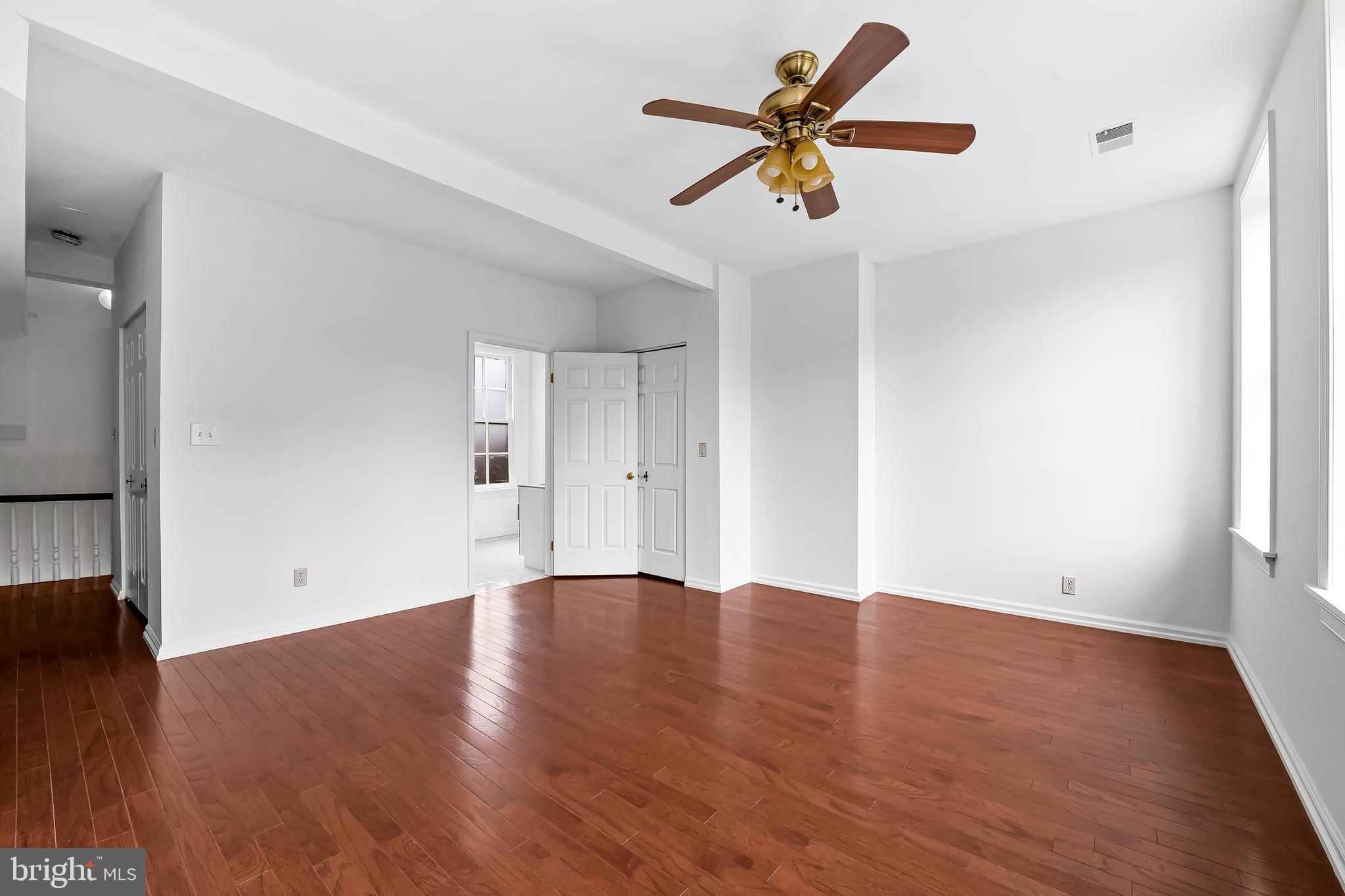 1431 Park Avenue Baltimore, MD 21217 - Photo 38 of 55 an empty room with wooden floor and windows