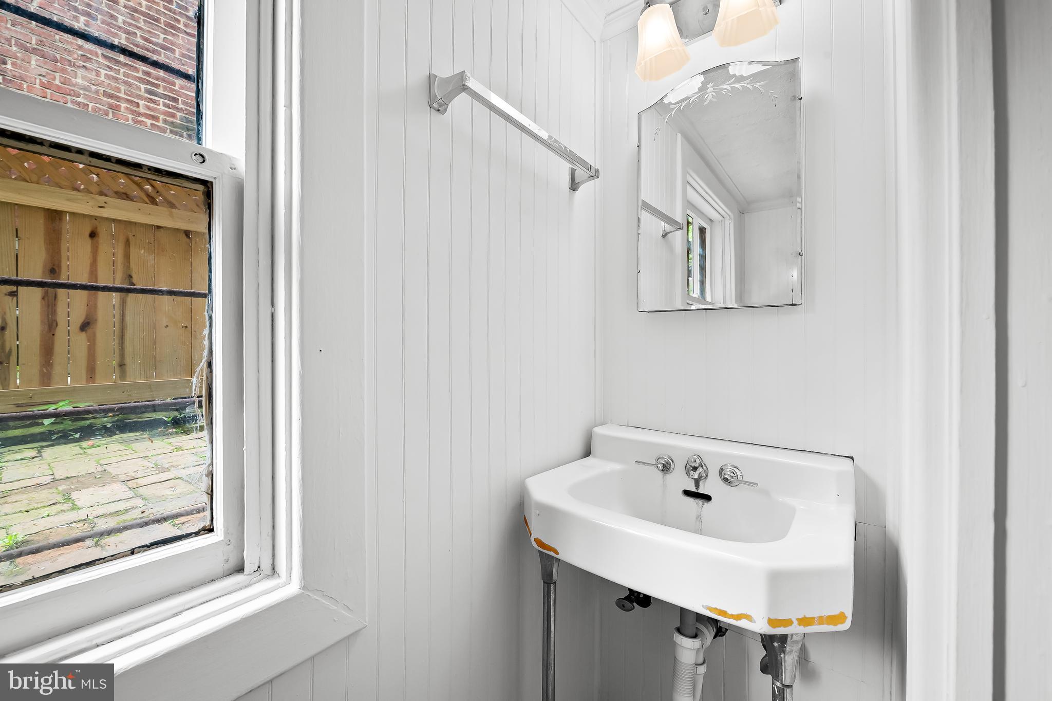 1431 Park Avenue Baltimore, MD 21217 - Photo 44 of 55 a bathroom with a sink and mirror