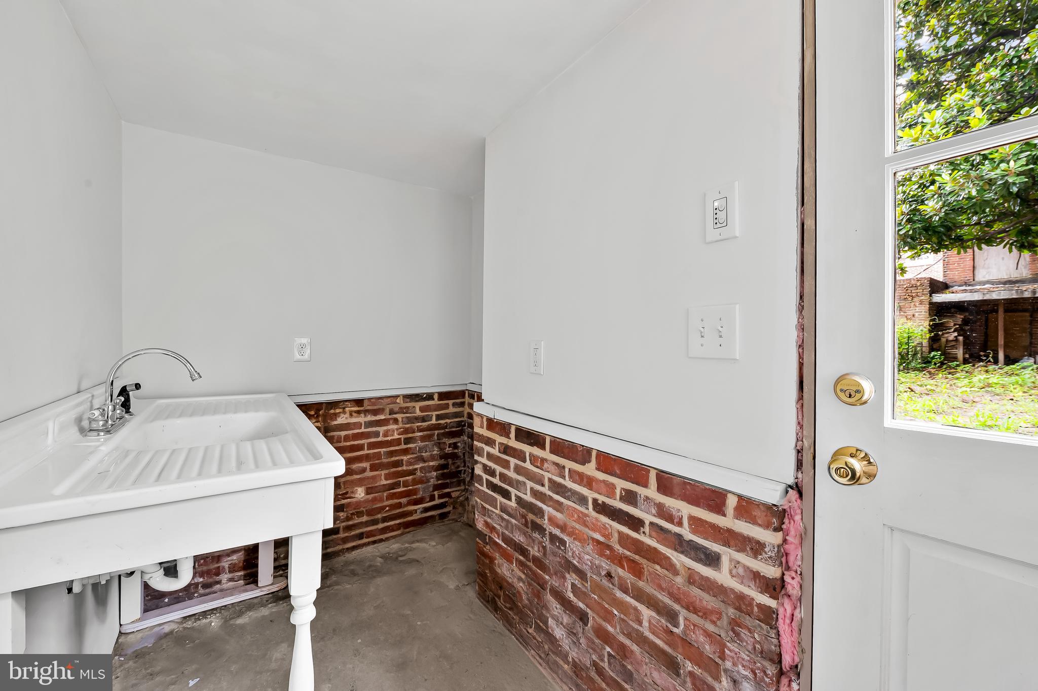 1431 Park Avenue Baltimore, MD 21217 - Photo 47 of 55 a bathroom with a sink and a window