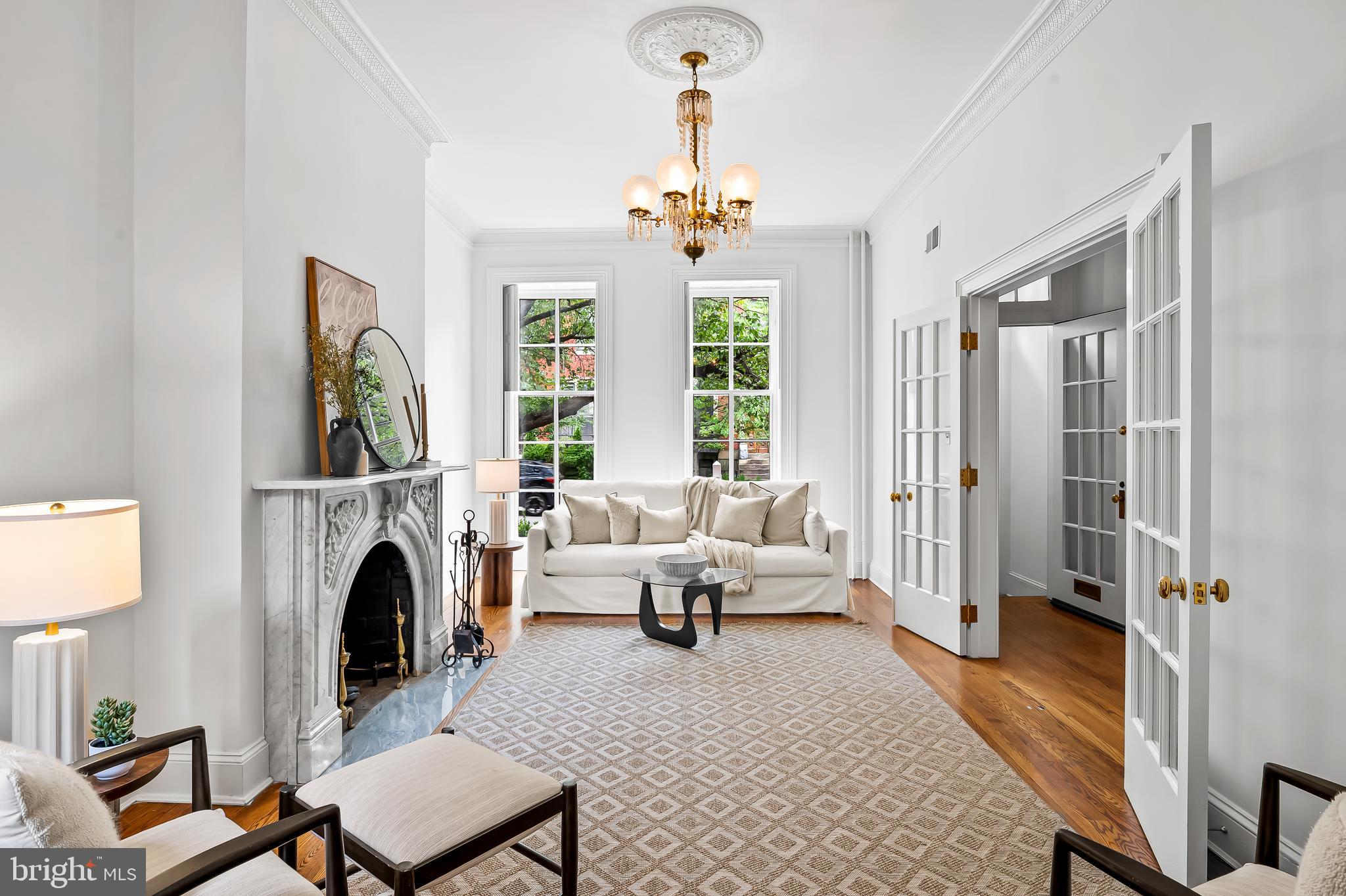 1431 Park Avenue Baltimore, MD 21217 - Photo 8 of 55 a living room with furniture a fireplace and a chandelier