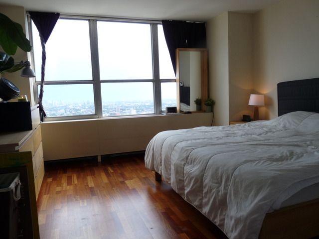 655 West Irving Park Road, Unit 4317 Chicago, IL 60613 - Photo 15 of 25 a bed sitting in a bedroom next to a window