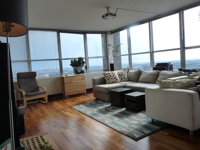 655 West Irving Park Road, Unit 4317 Chicago, IL 60613 - Photo 4 of 25 a living room with furniture and a floor to ceiling window