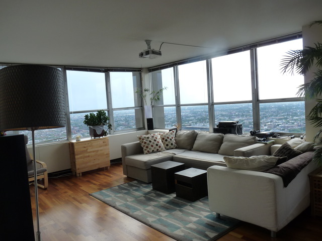 655 West Irving Park Road, Unit 4317 Chicago, IL 60613 - Photo 5 of 25 a living room with furniture and a large window