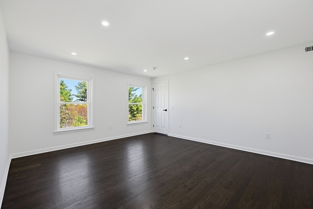 175 Pleasant Street Upton, MA 01568 - Photo 24 of 39 an empty room with wooden floor and windows