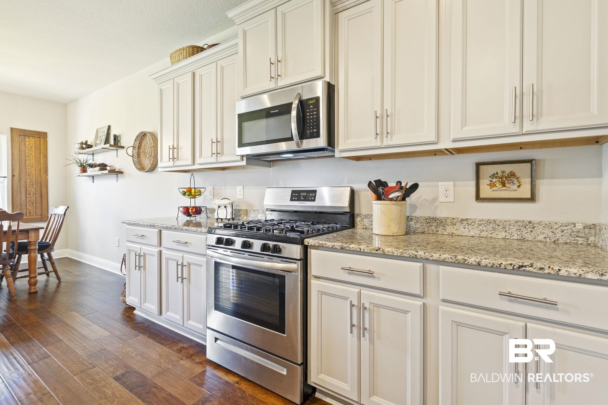 31663 Kestrel Loop Daphne, AL 36527 - Photo 26 of 86 Kitchen with dark hardwood / wood-style floors, light stone countertops, and appliances with stainless steel finishes