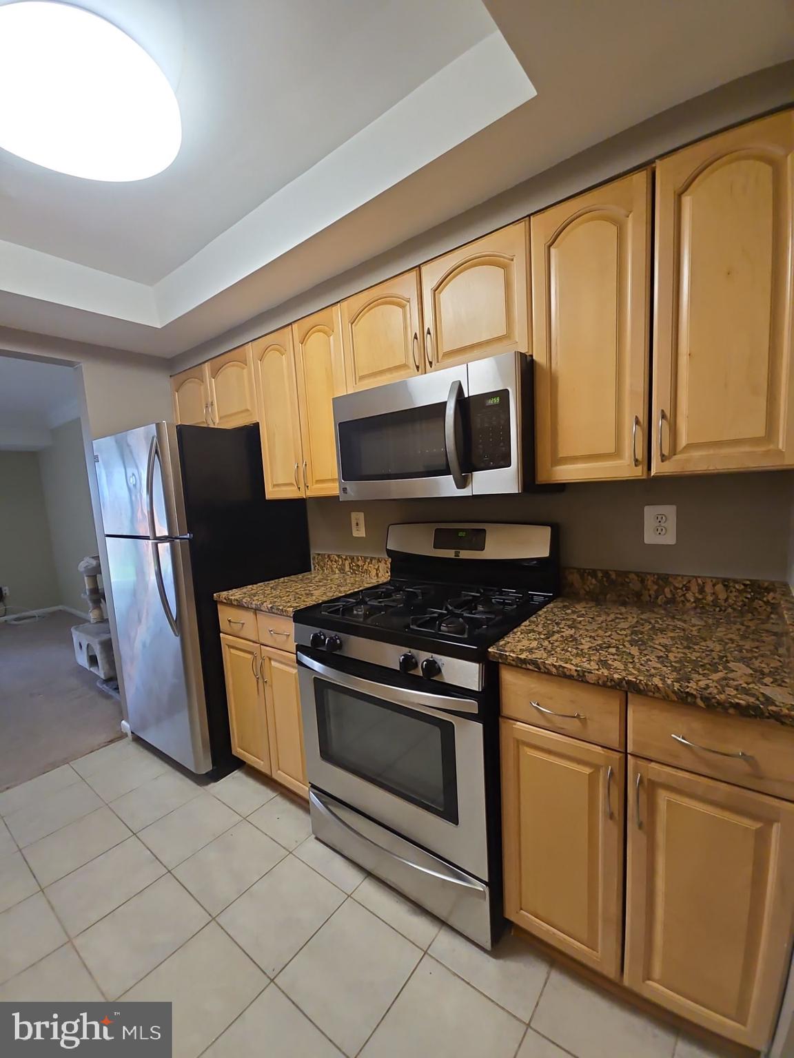 2115 Mager Drive Herndon, VA 20170 - Photo 11 of 41 a kitchen with stainless steel appliances granite countertop a stove a sink and a microwave