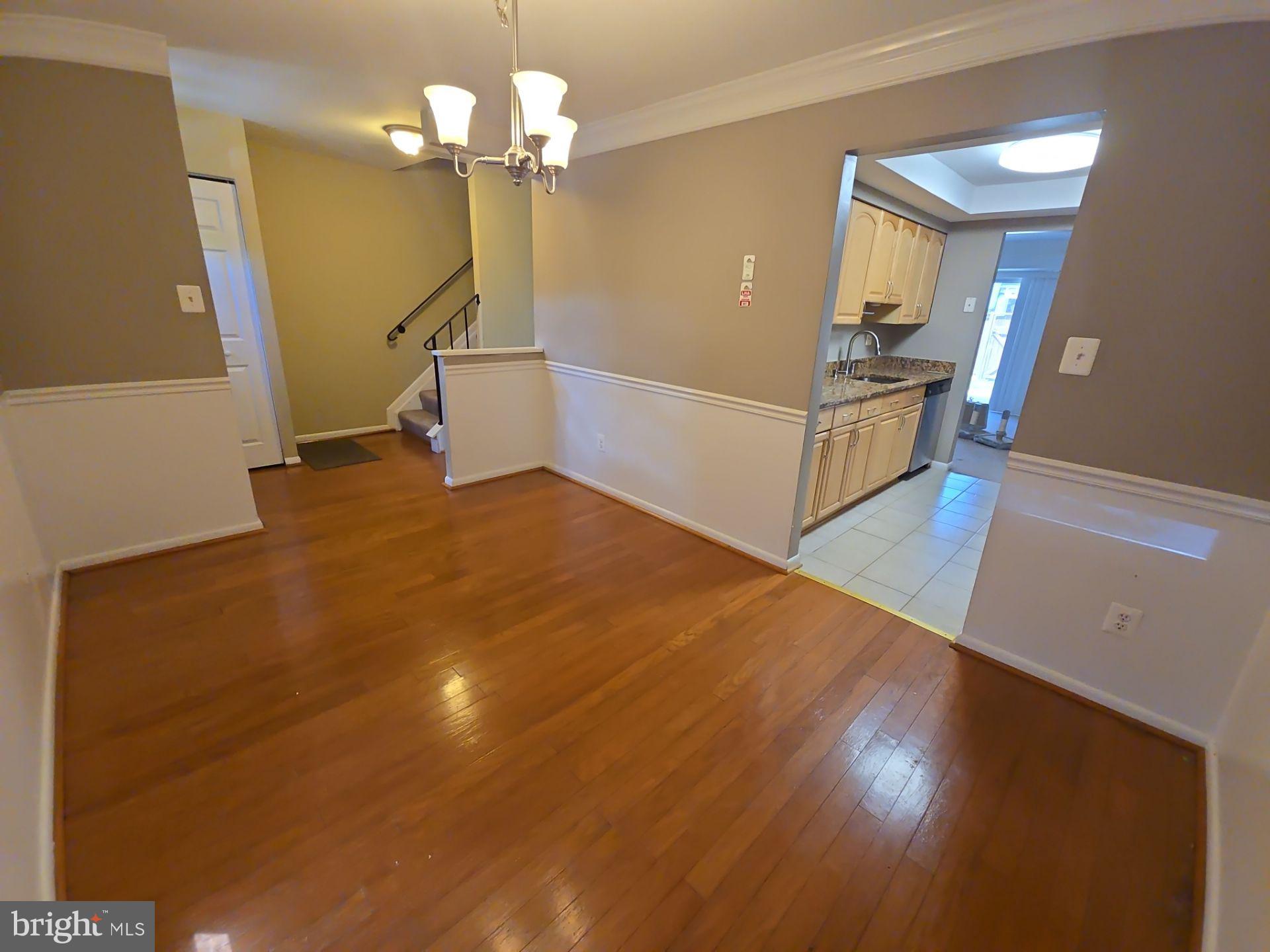 2115 Mager Drive Herndon, VA 20170 - Photo 5 of 41 a view of a livingroom with wooden floor and a ceiling fan