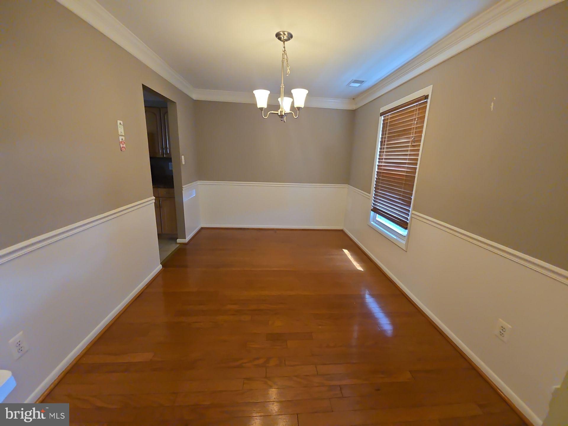2115 Mager Drive Herndon, VA 20170 - Photo 6 of 41 a view of empty room with chandelier fan and wooden floor