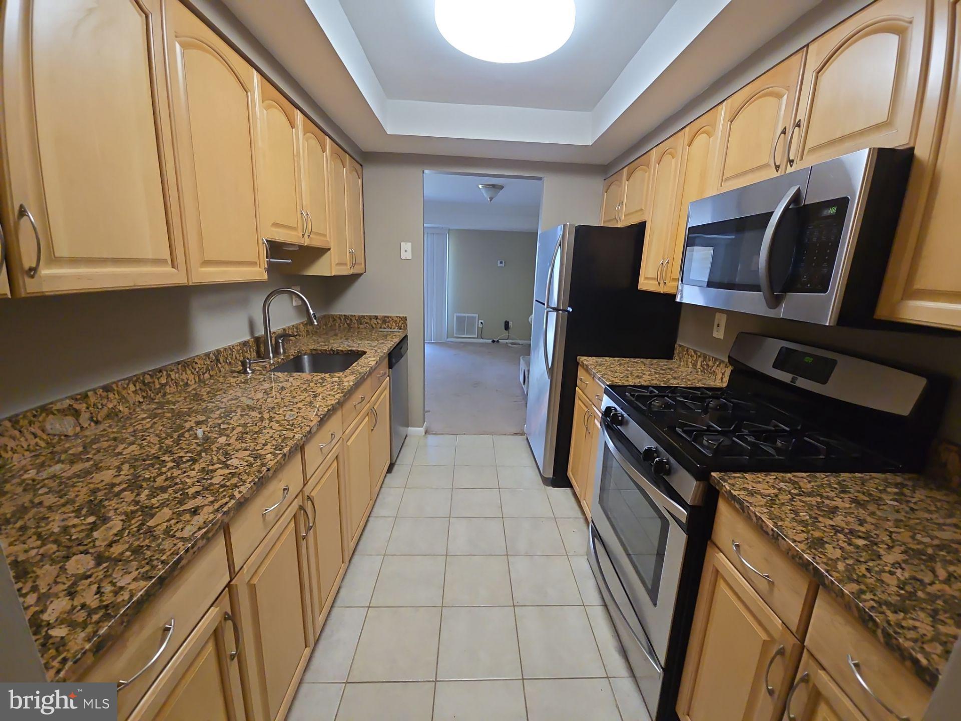 2115 Mager Drive Herndon, VA 20170 - Photo 8 of 41 a kitchen with stainless steel appliances granite countertop a stove and a sink