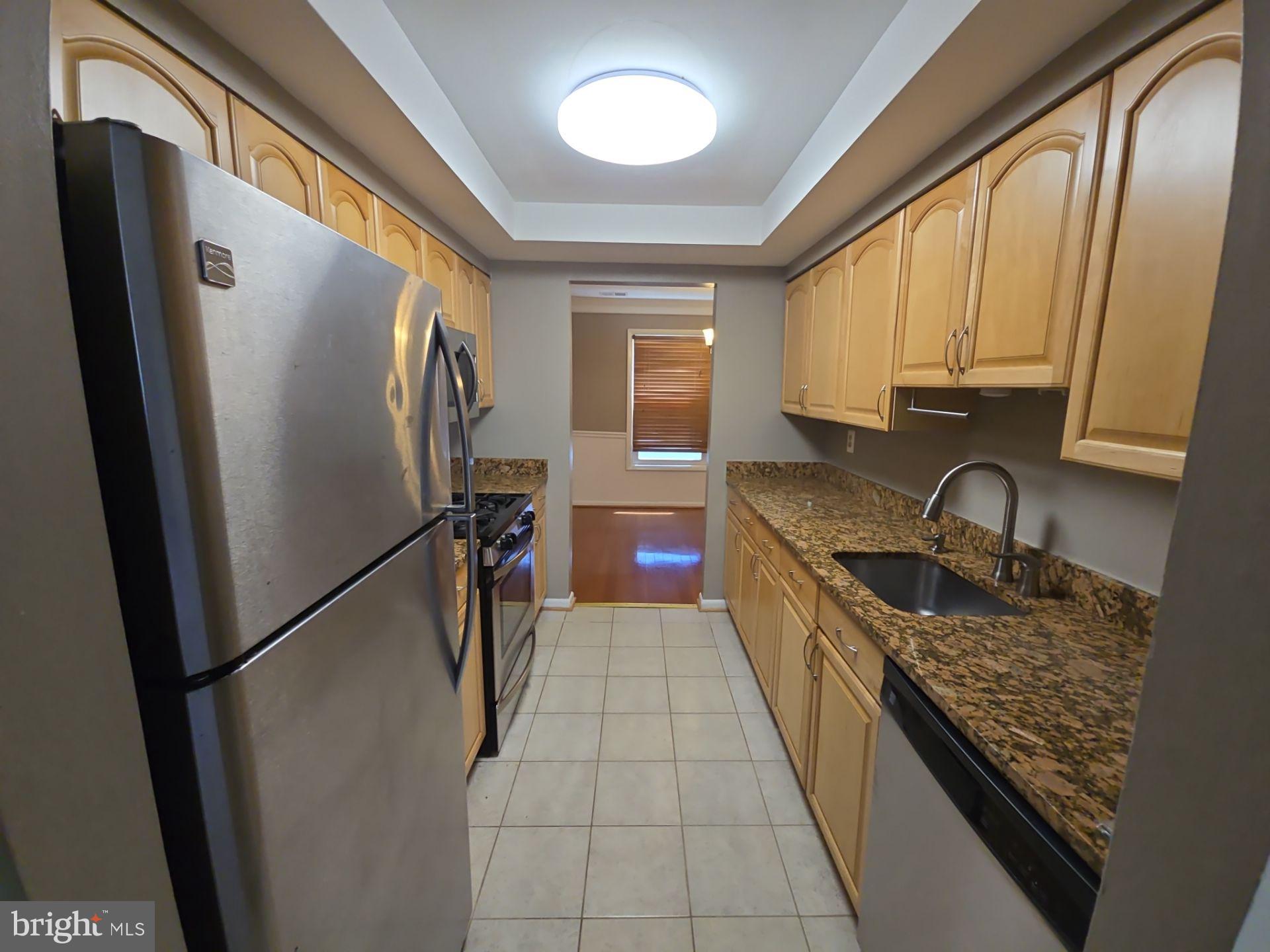 2115 Mager Drive Herndon, VA 20170 - Photo 9 of 41 a kitchen with stainless steel appliances granite countertop a refrigerator and a stove